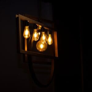 A light fixture hanging from the ceiling in a dark room.