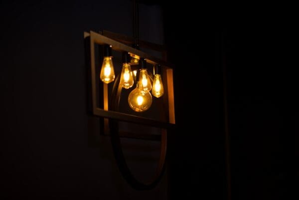 A light fixture hanging from the ceiling in a dark room.