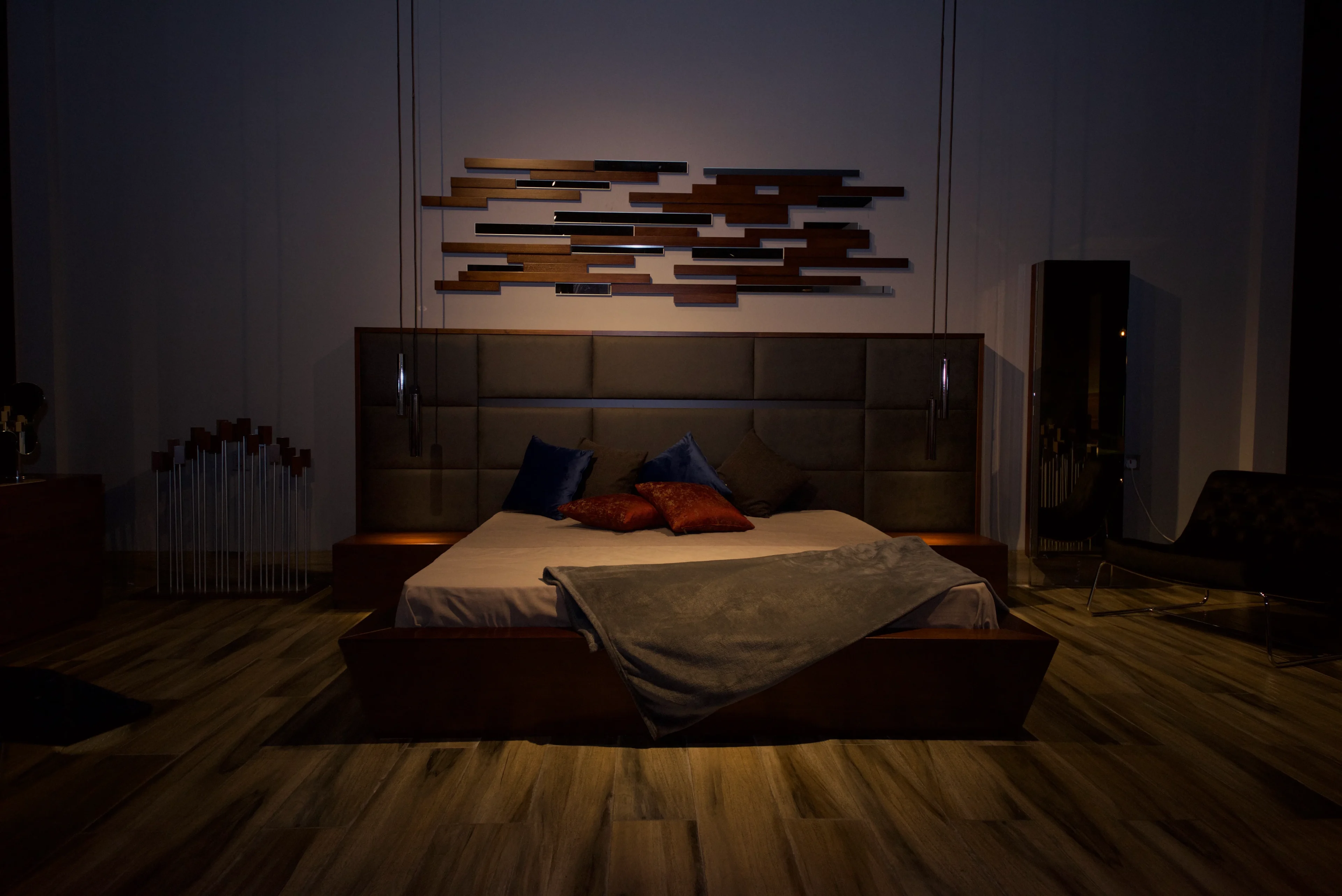 A bed room with a wooden headboard and floor