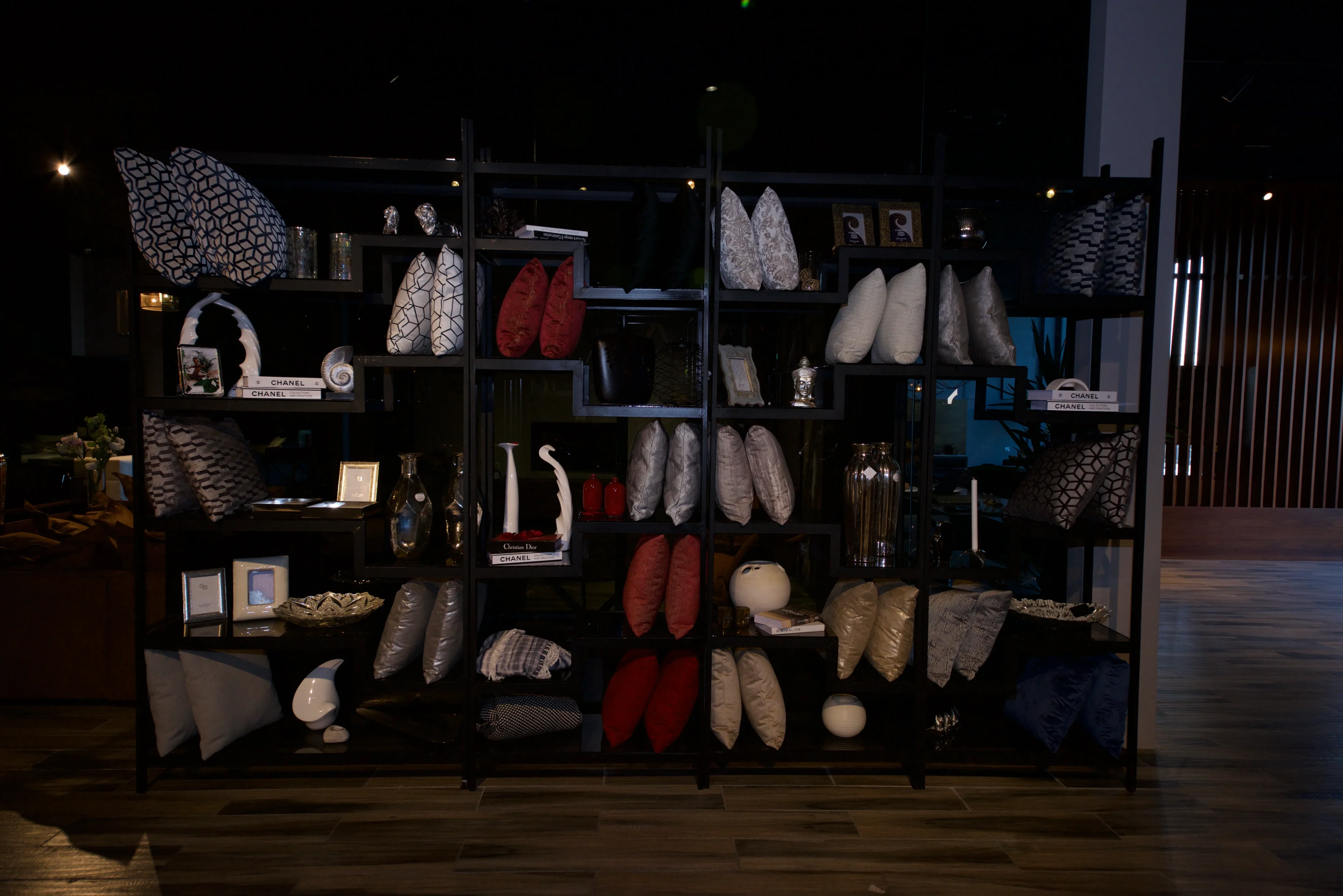 A room filled with shelves of shoes and bags.