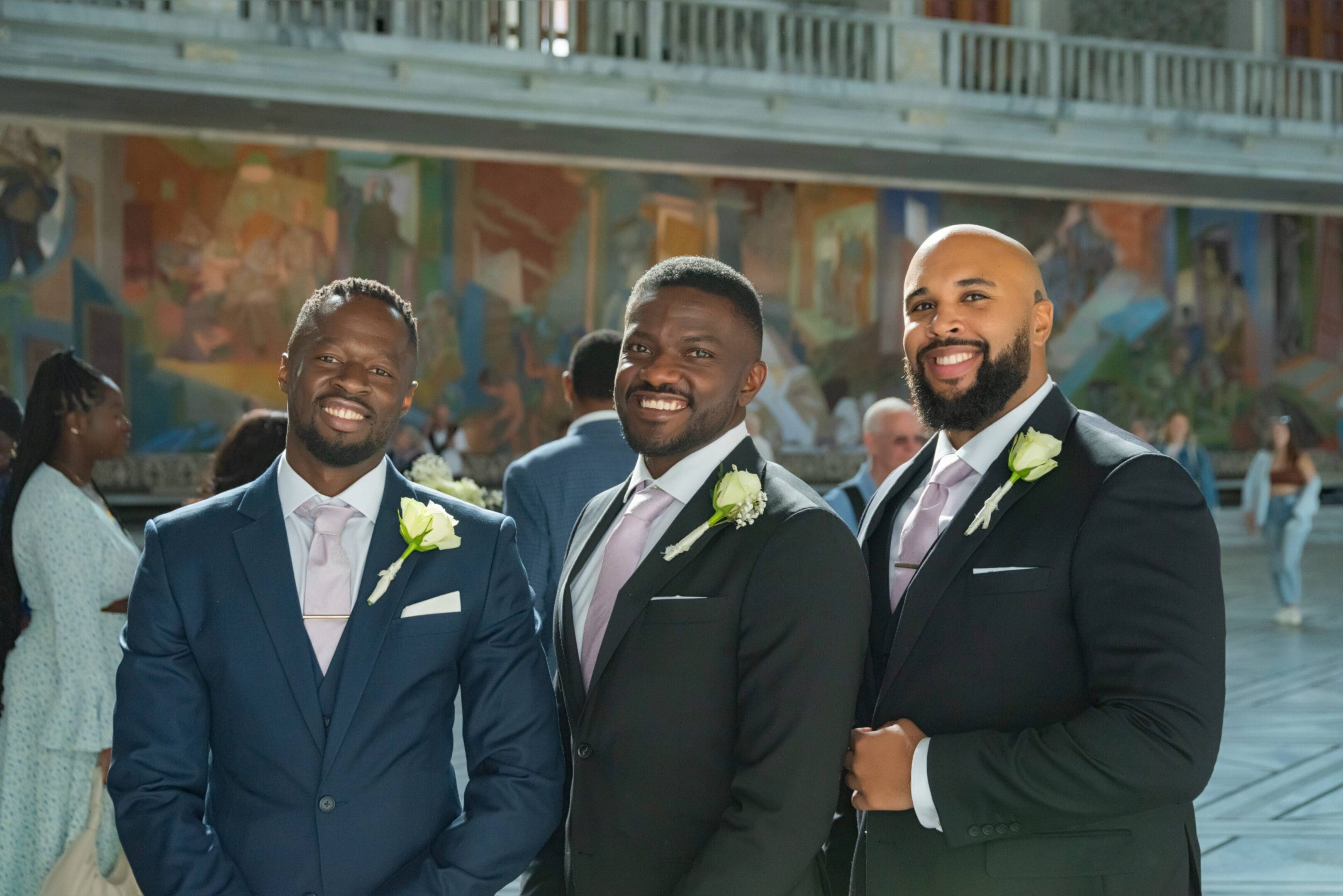 Three men in suits and ties posing for a picture.