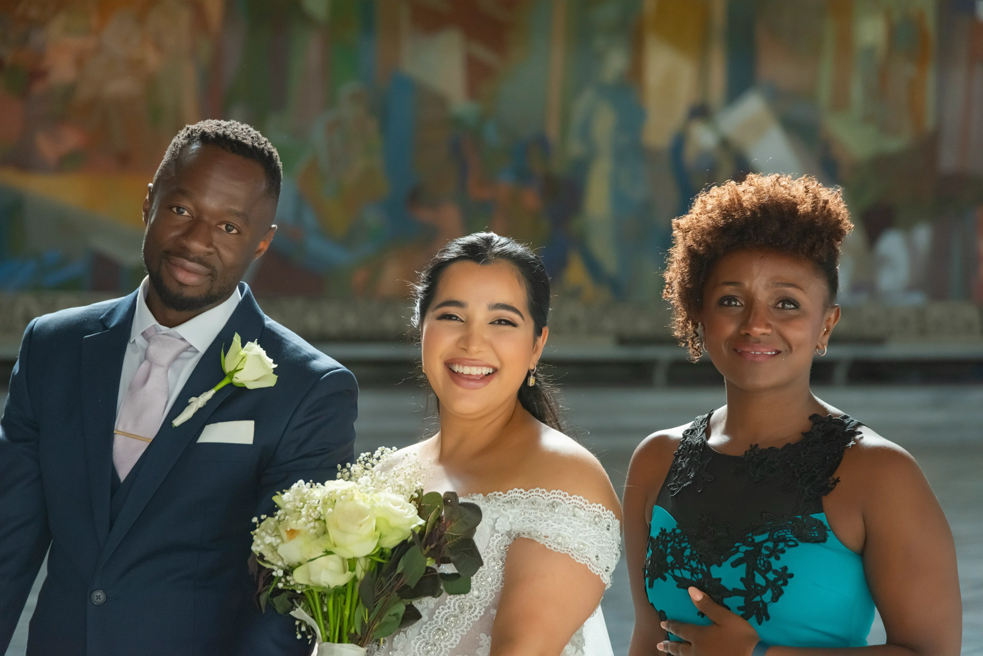 A couple and their wedding party posing for the camera.