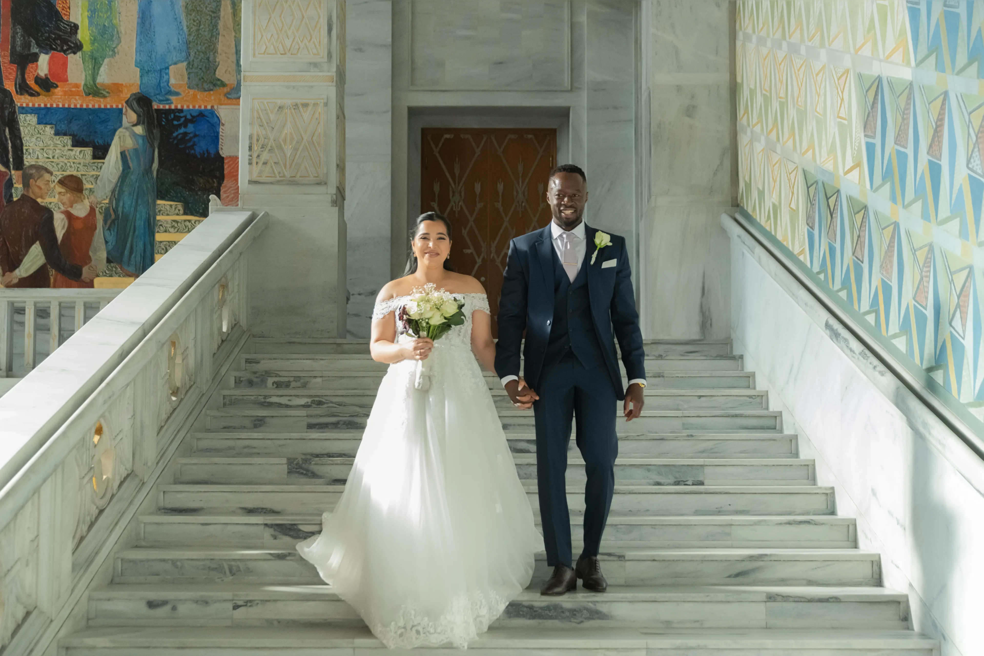 A man and woman walking down the stairs.