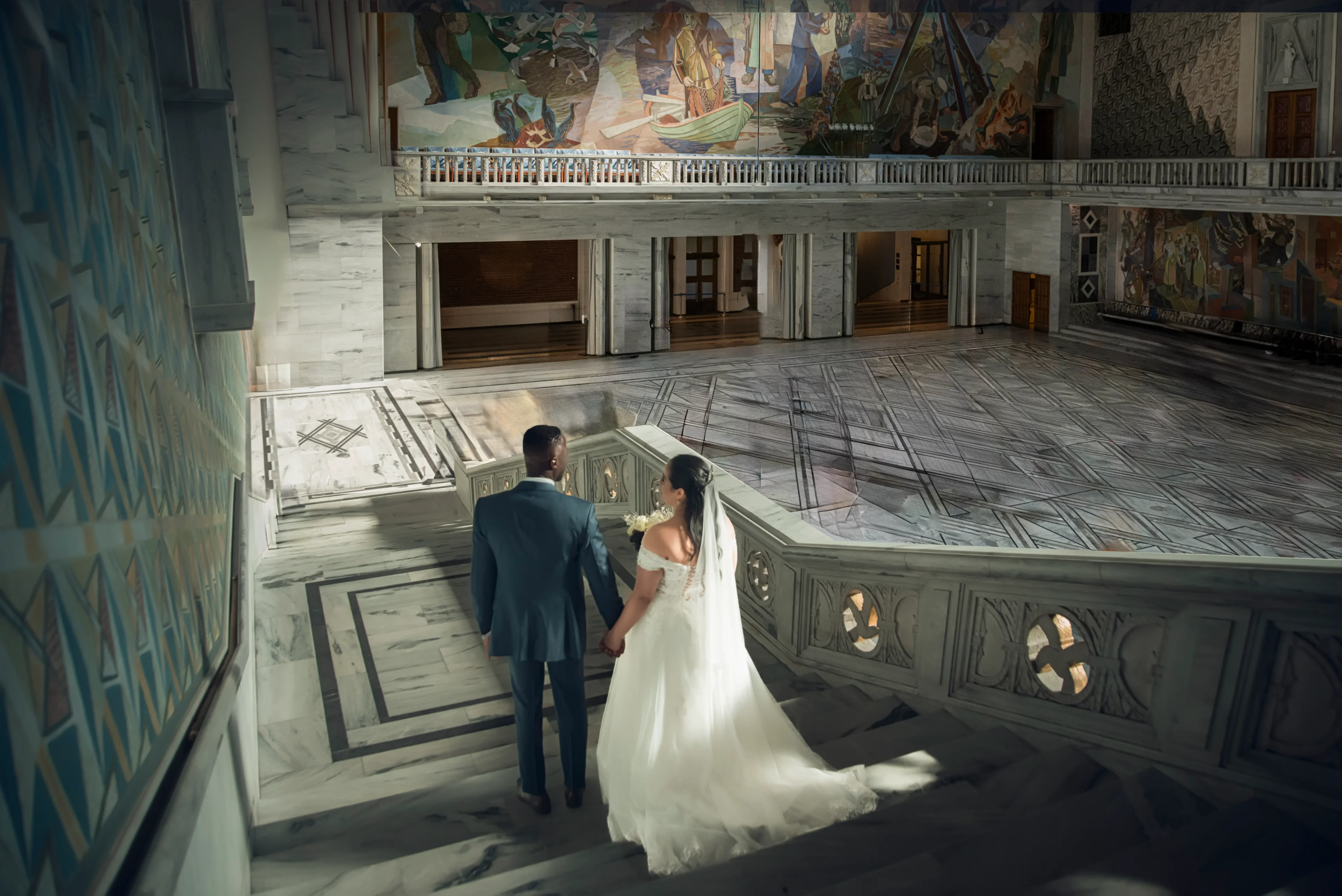 A bride and groom walking up the stairs